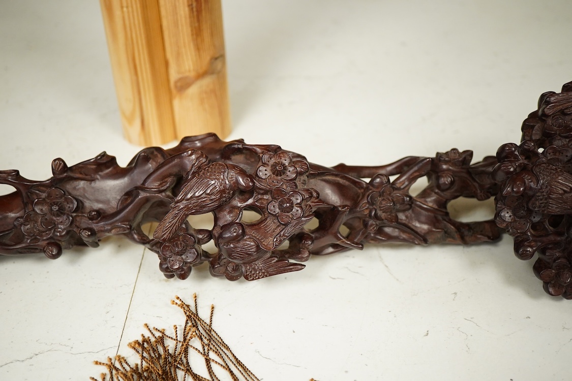 A Chinese carved hardwood Ruyi sceptre, with two porcelain ‘dragon’ beads, 50cm in length